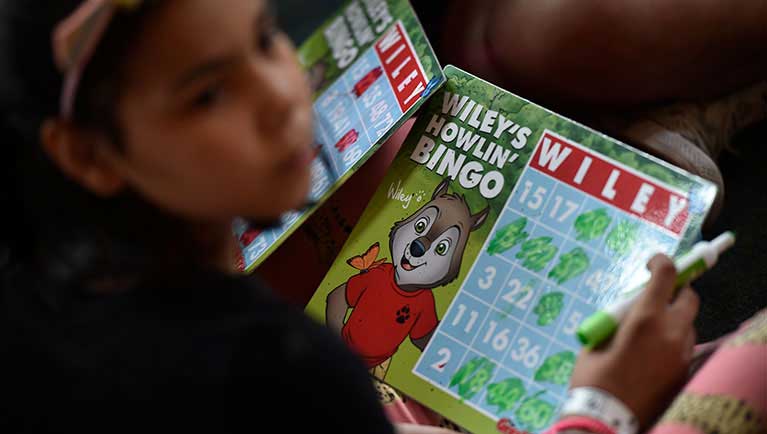 kid showing an employee his Bingo card