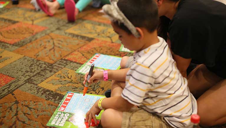 Kids in wolf ears playing Bingo