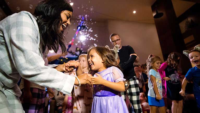 Mother and daughter dancing at dance party