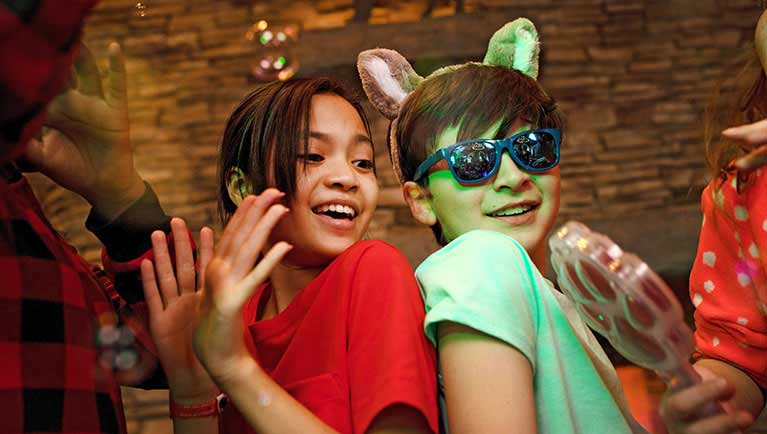 Two boys wearing sunglasses and dancing at the dance party