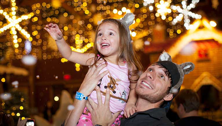 dad holding daughter during festive celebration