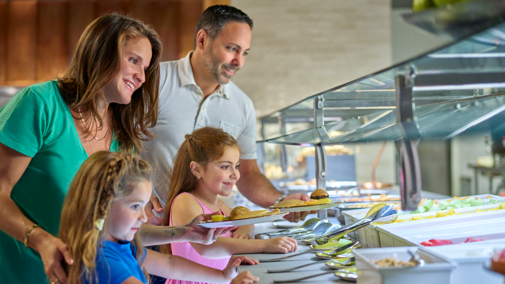 Mother at a breakfast buffet with her kids