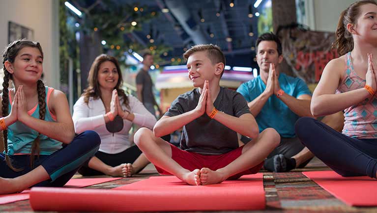 families take part in a yoga class
