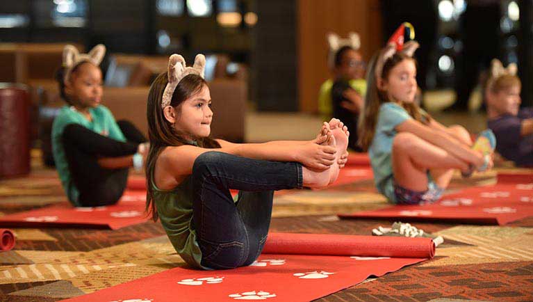 families take part in a yoga class
