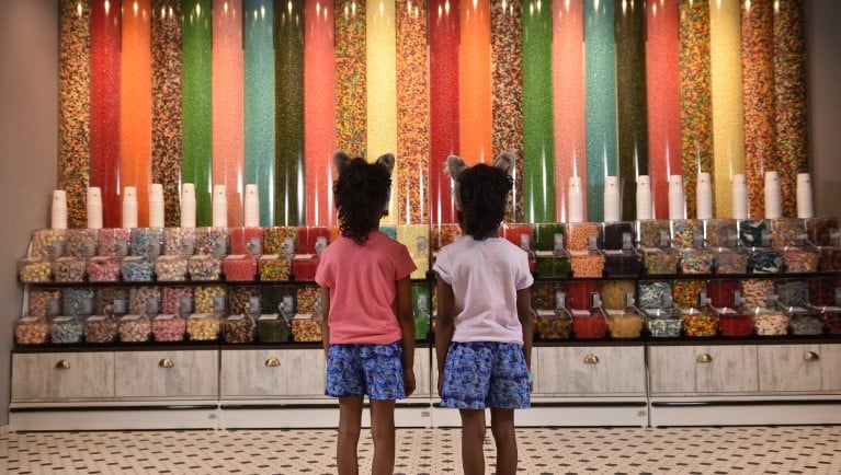 two girls looks at the candy towers.