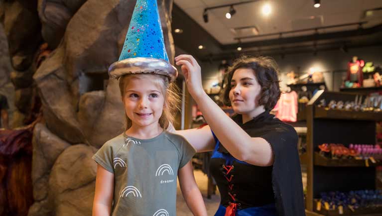 girl wearing a magiquest themed hat