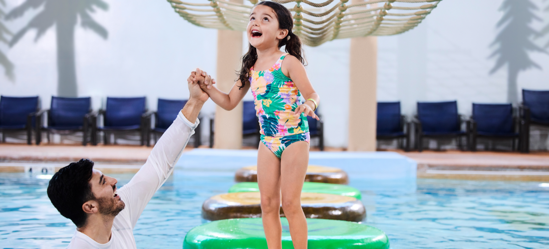 father and daughter enjoying in a pool at the waterpark