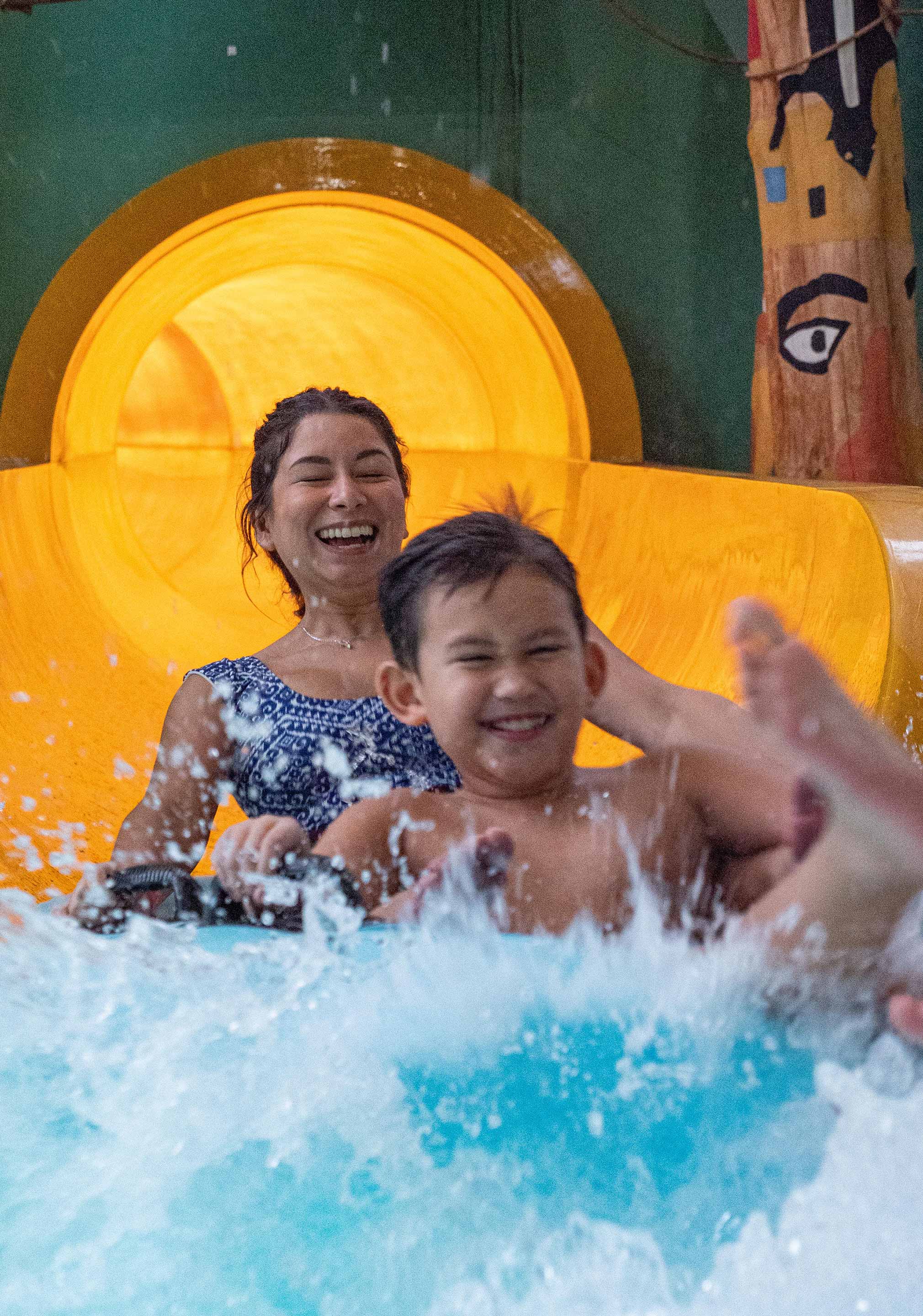 Mother and son on a water slide tube