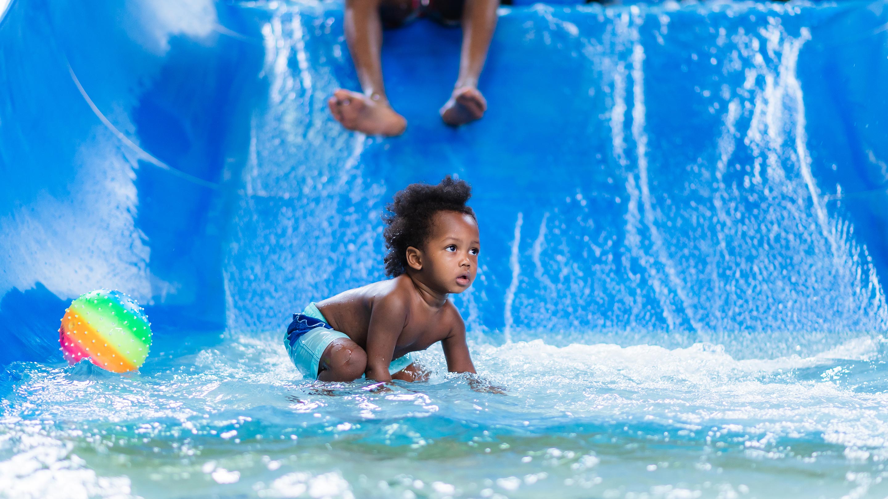 child playing in a kiddie pool