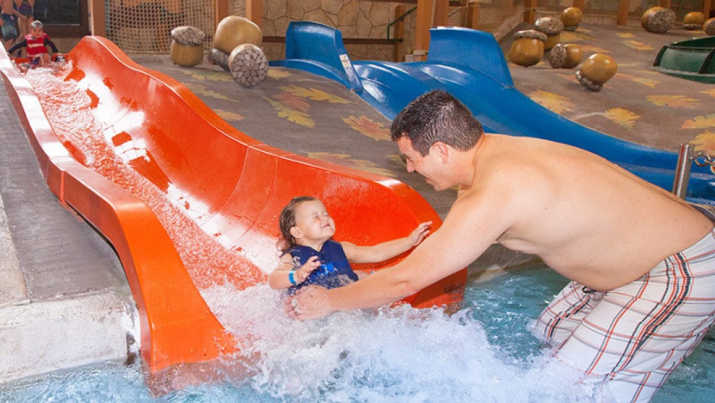 A toddle enjoying with his dad at kiddie slides