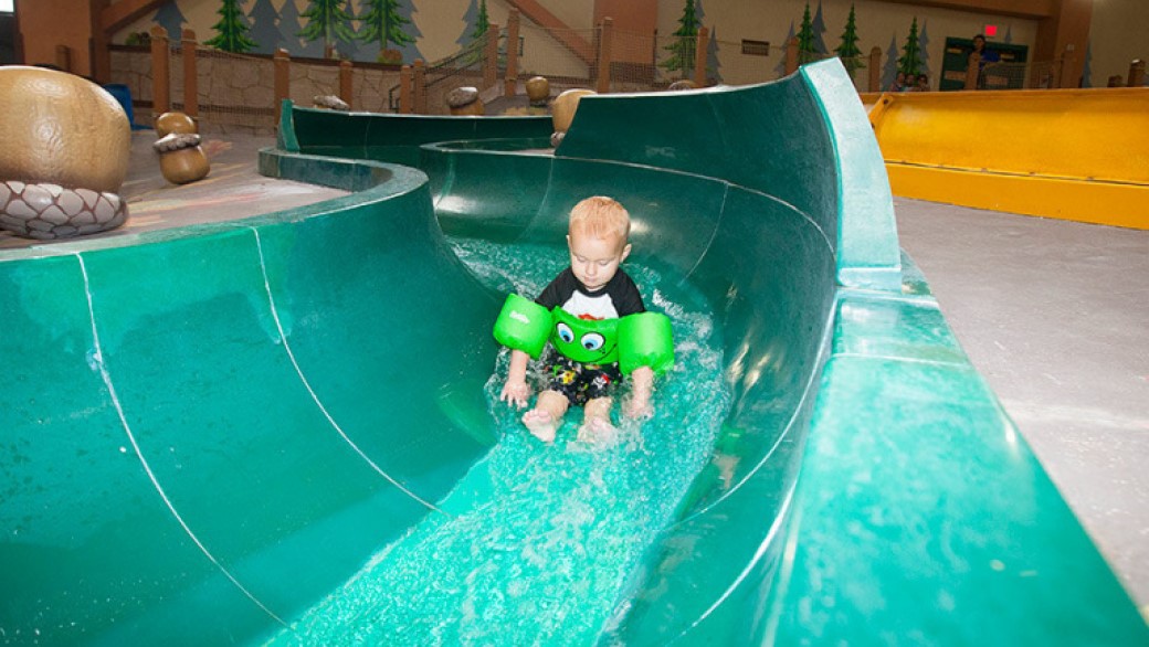 Child floating down the kiddie slides at Great Wolf Lodge