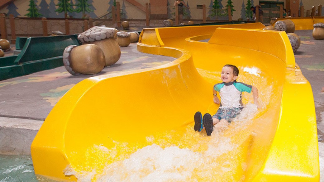 Boy sliding down the slide at Kiddie slides