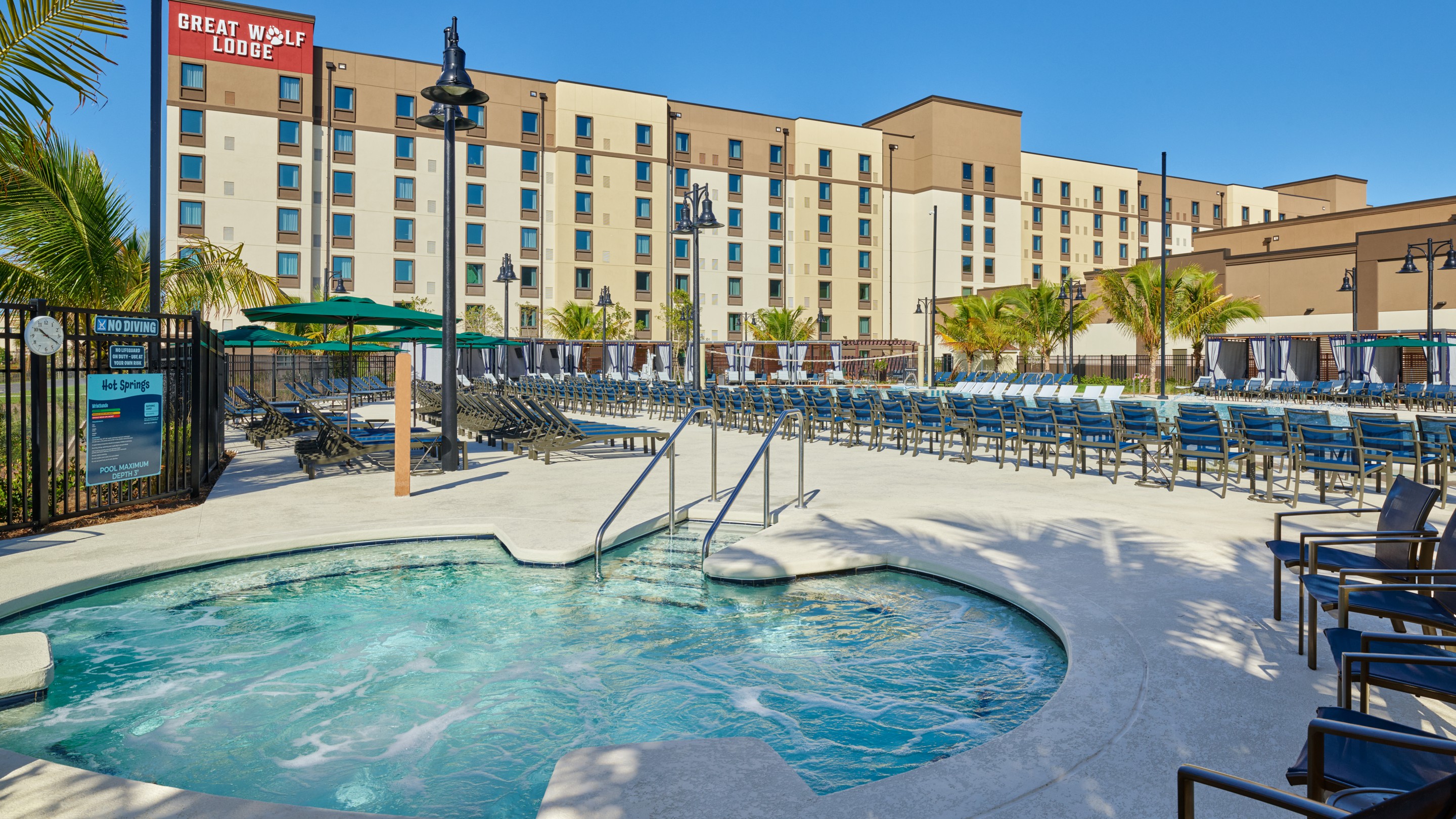 view of an outdoor hot tub and palm trees