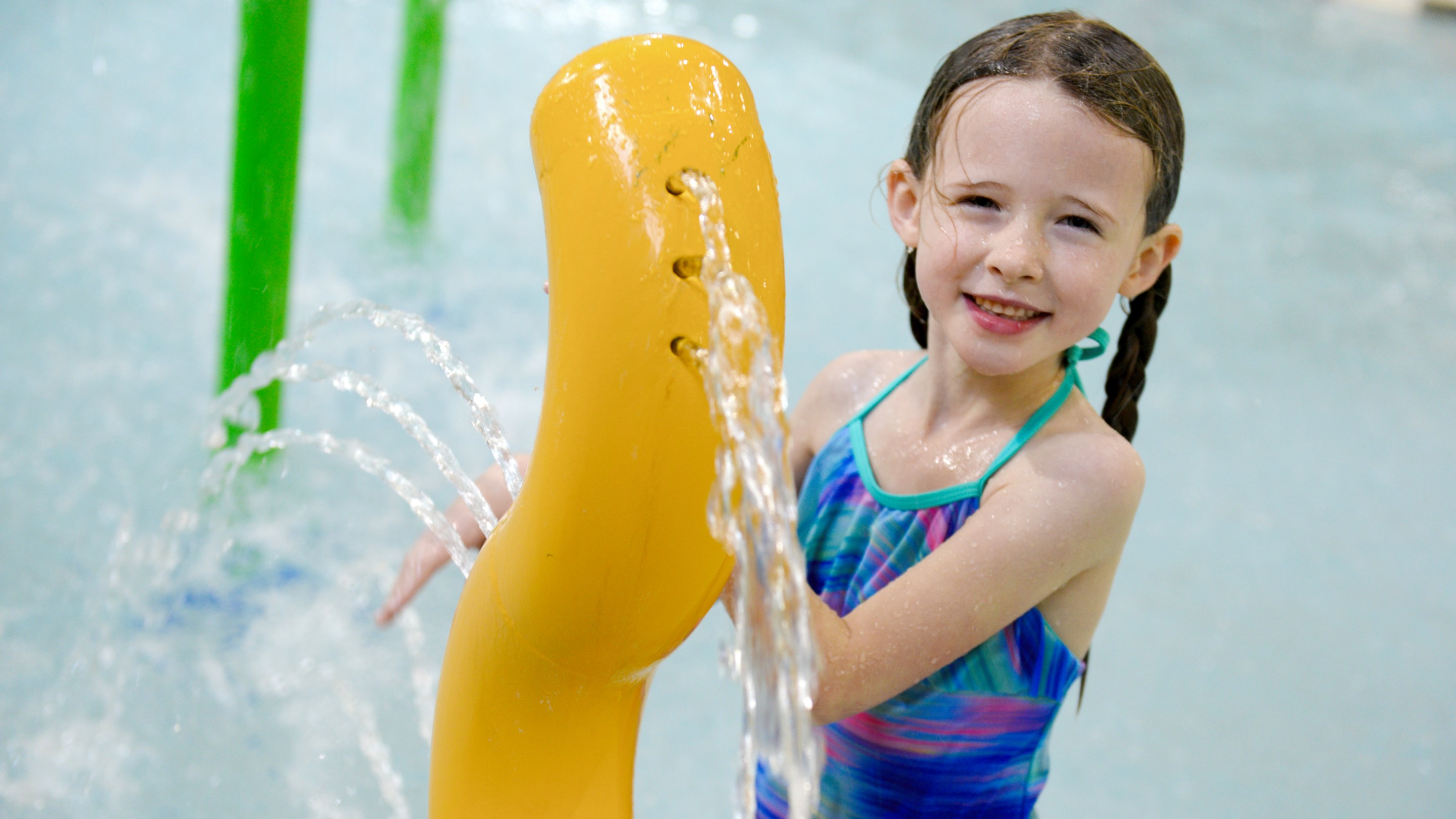 girl child playing in a kiddie pool