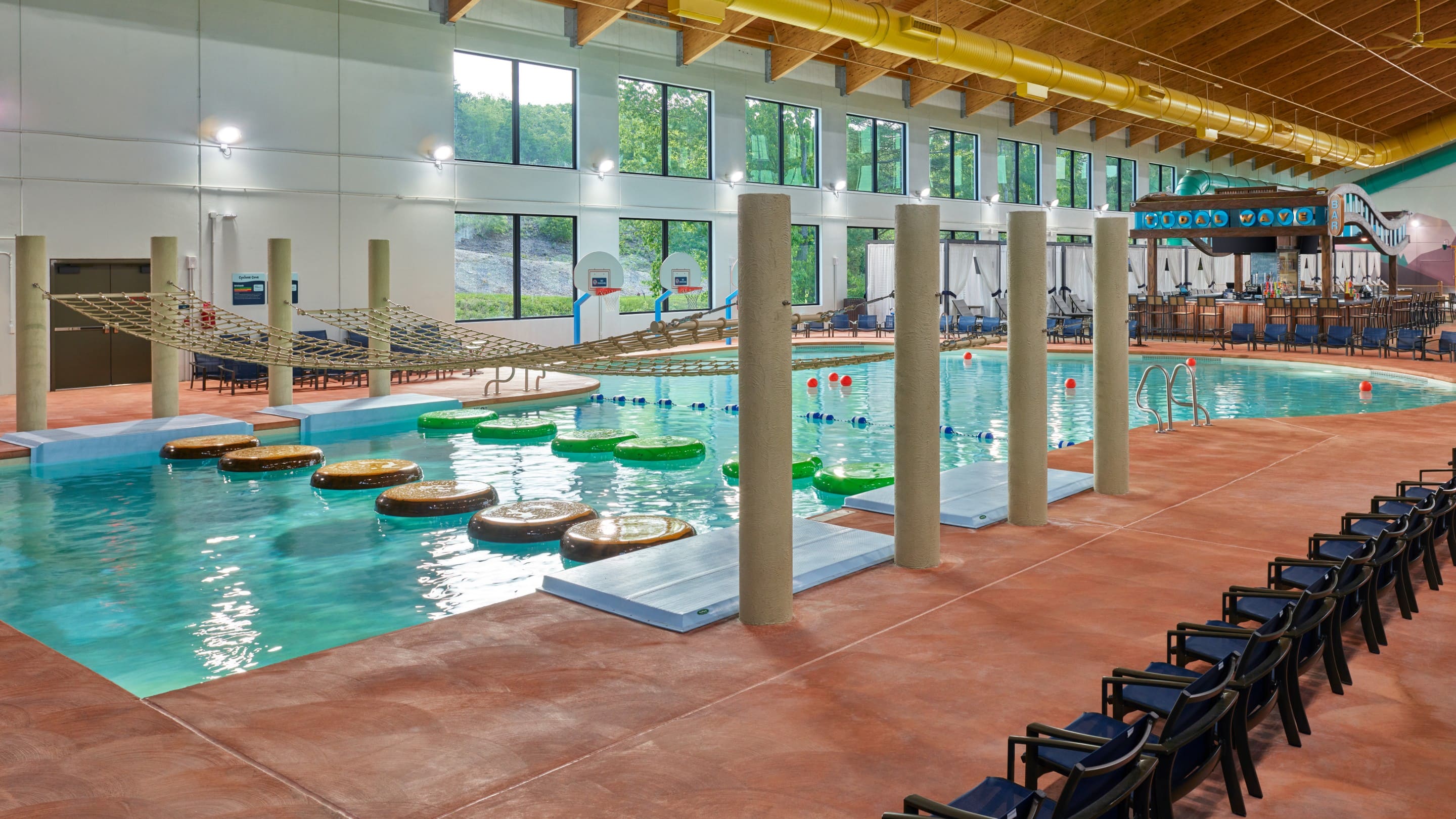 family playing basketball in indoor pool