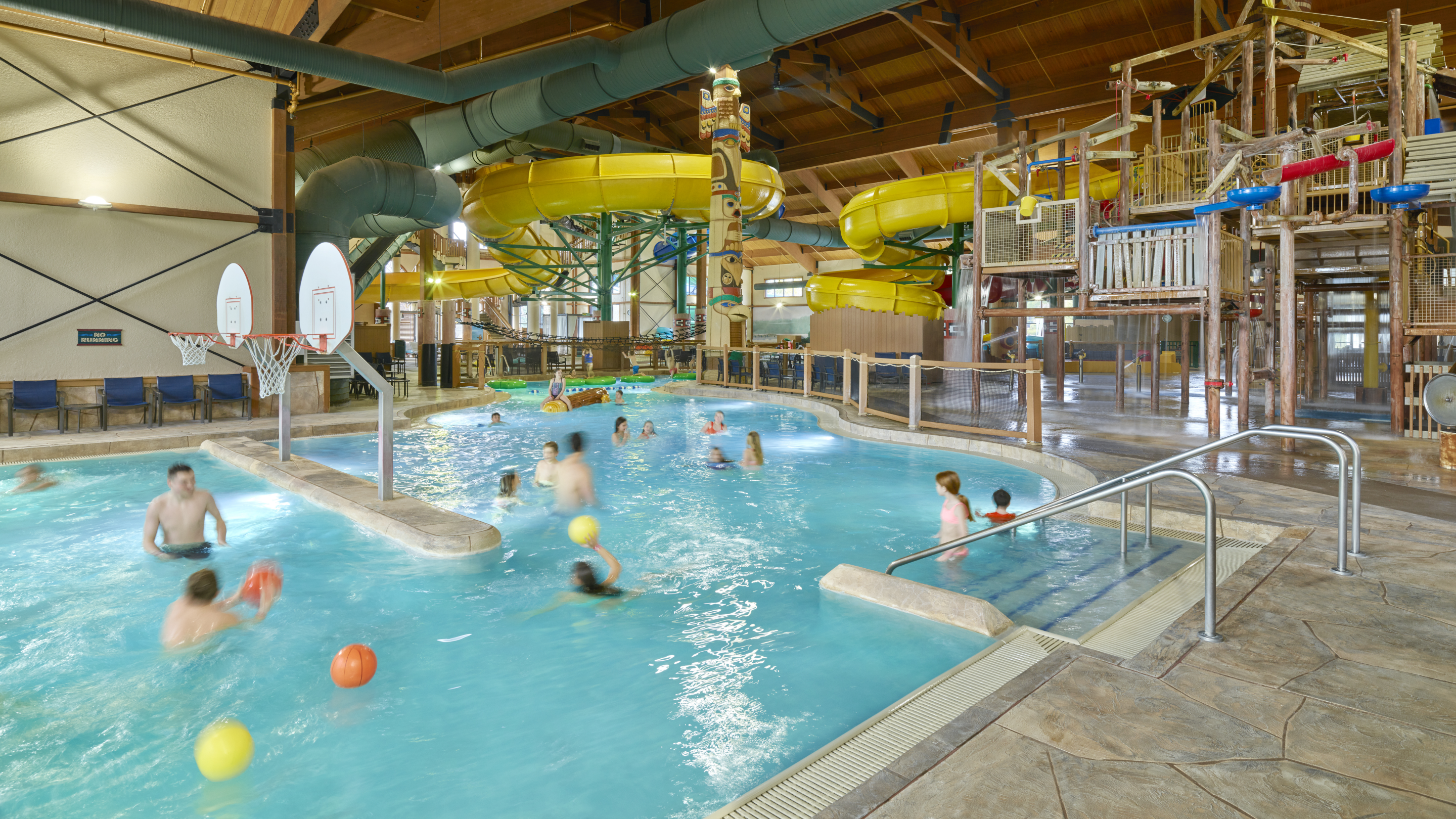 Families enjoying in the indoor water park pool