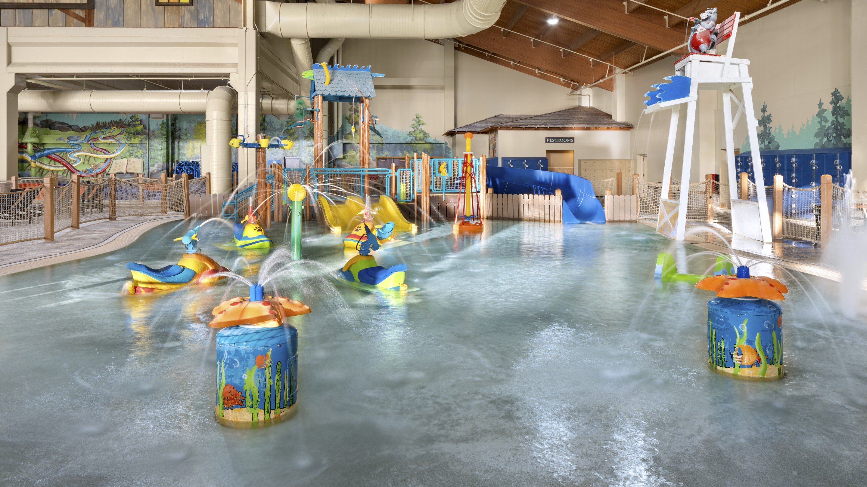A vibrant water park featuring a large slide and a fun water play area for children.