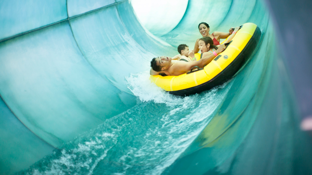A family of four ride a tube down Great Wolf Lodge’s Double Whirlwind.