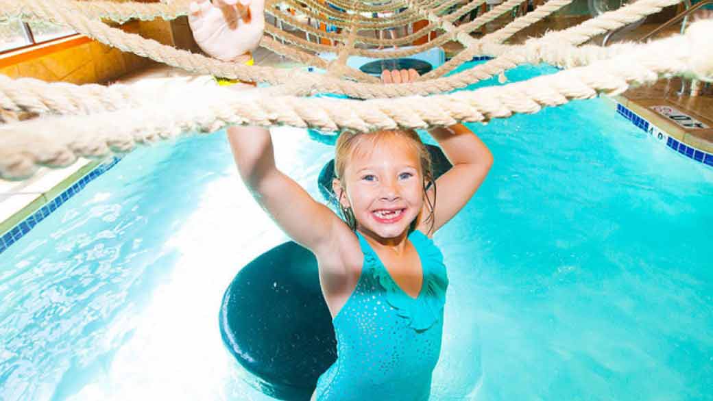 A girl smiles at camera while enjoying at Frog Bog Log Walk