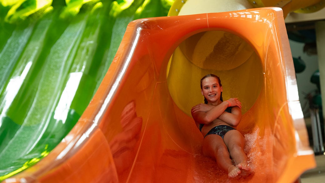 girl sliding down on a water slider