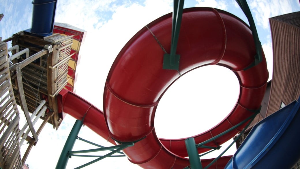 outdoor water attraction with 2 slides and a deck