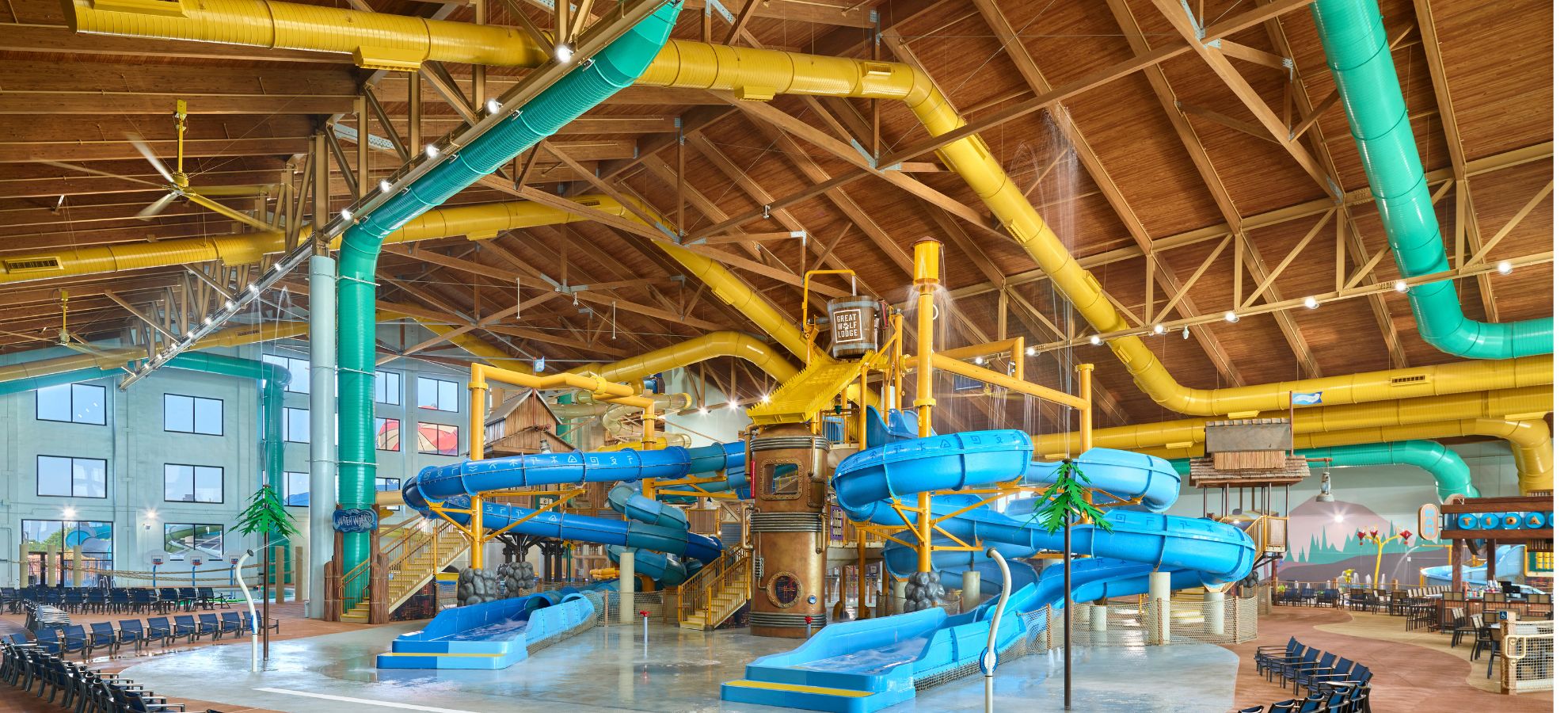 Water park fort with multiple slides and water bucket