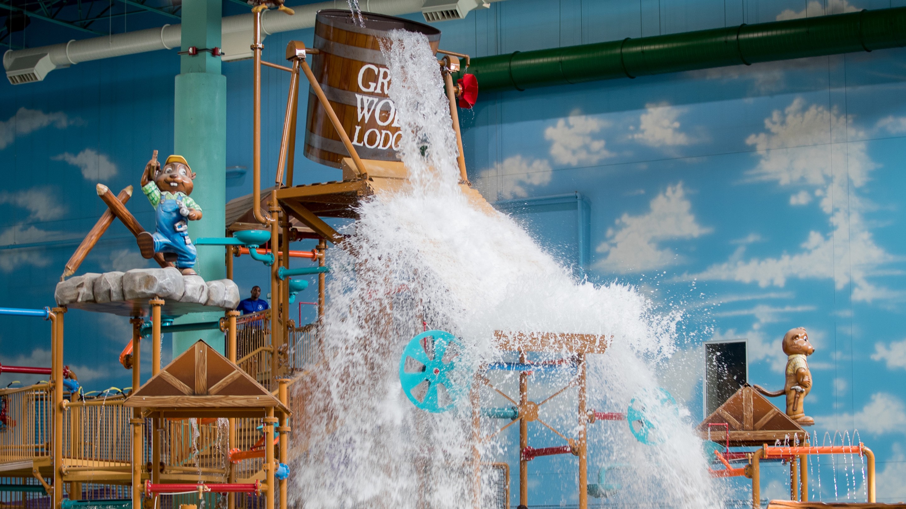 family laughing as they get soaked by water bucket