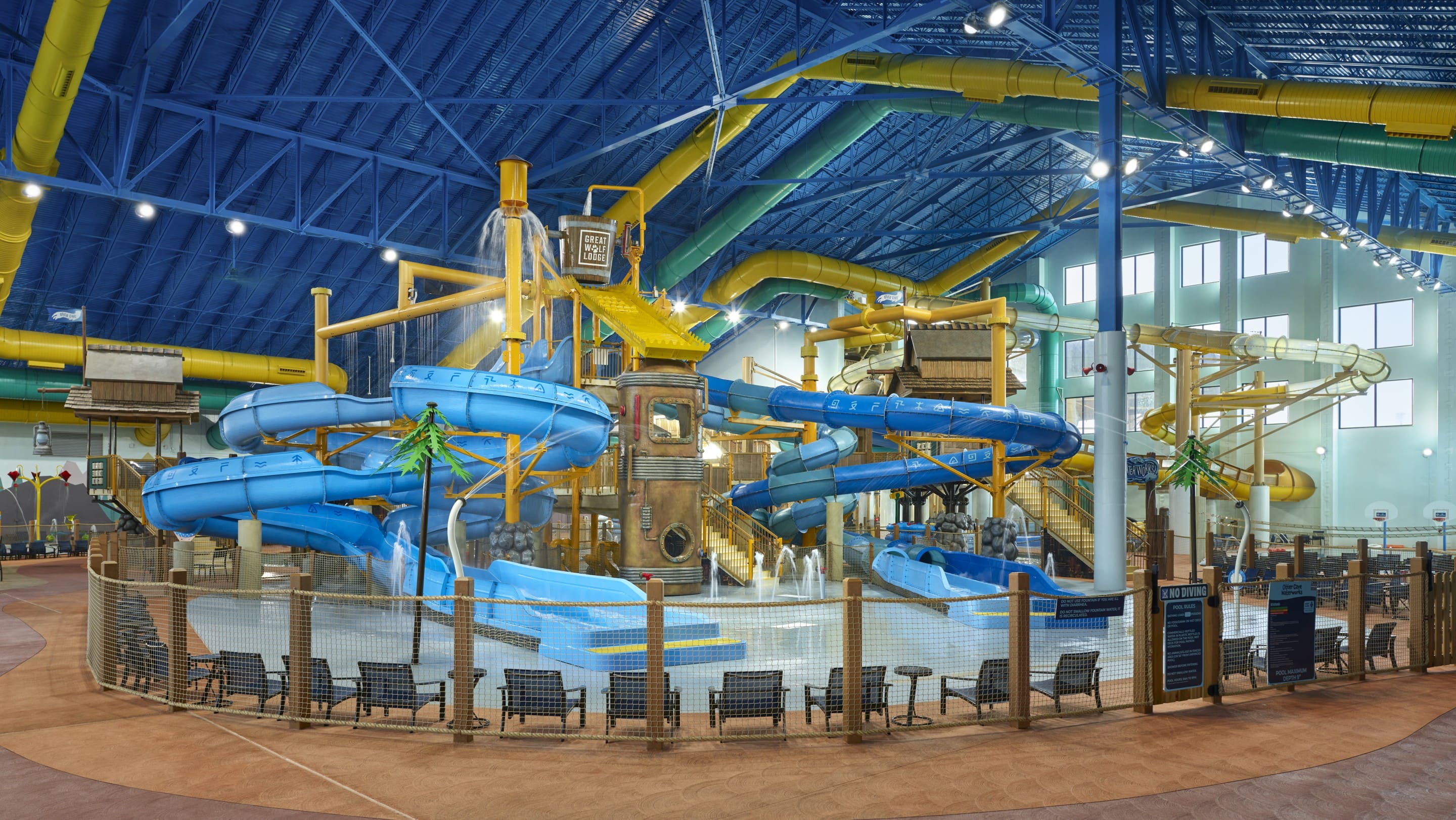 Water park fort with multiple slides and water bucket