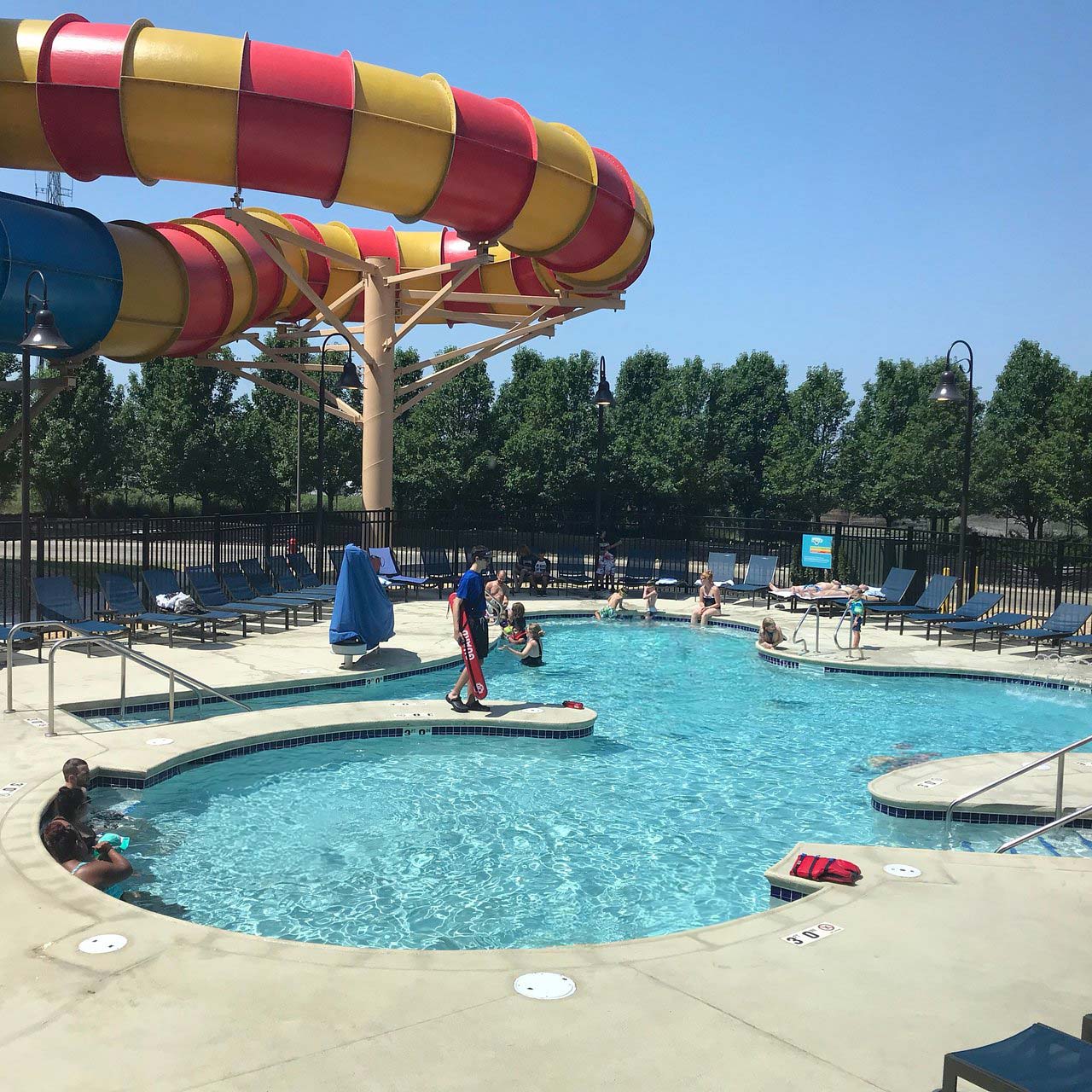 guests soaking up the sun in an outdoor pool