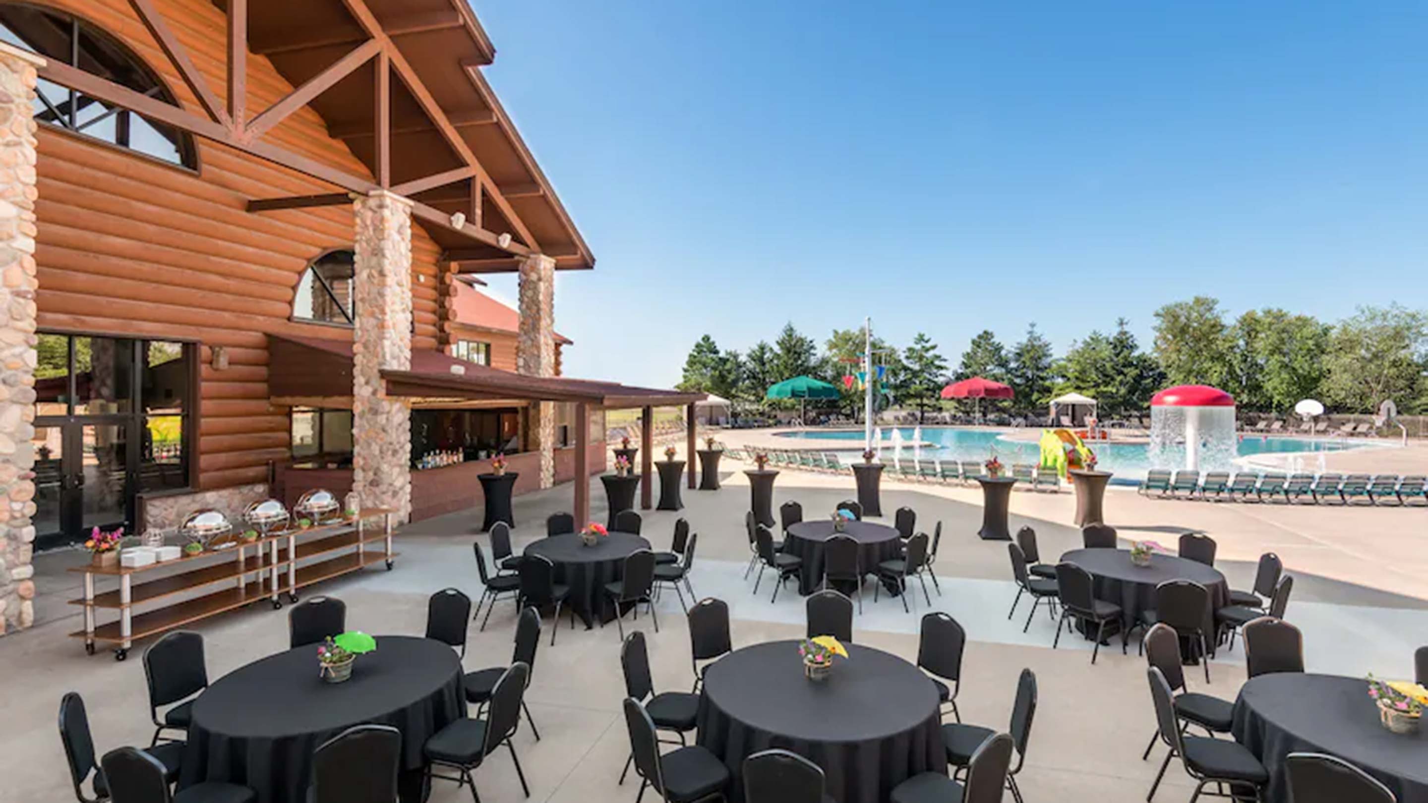 tables set up next to an outdoor pool