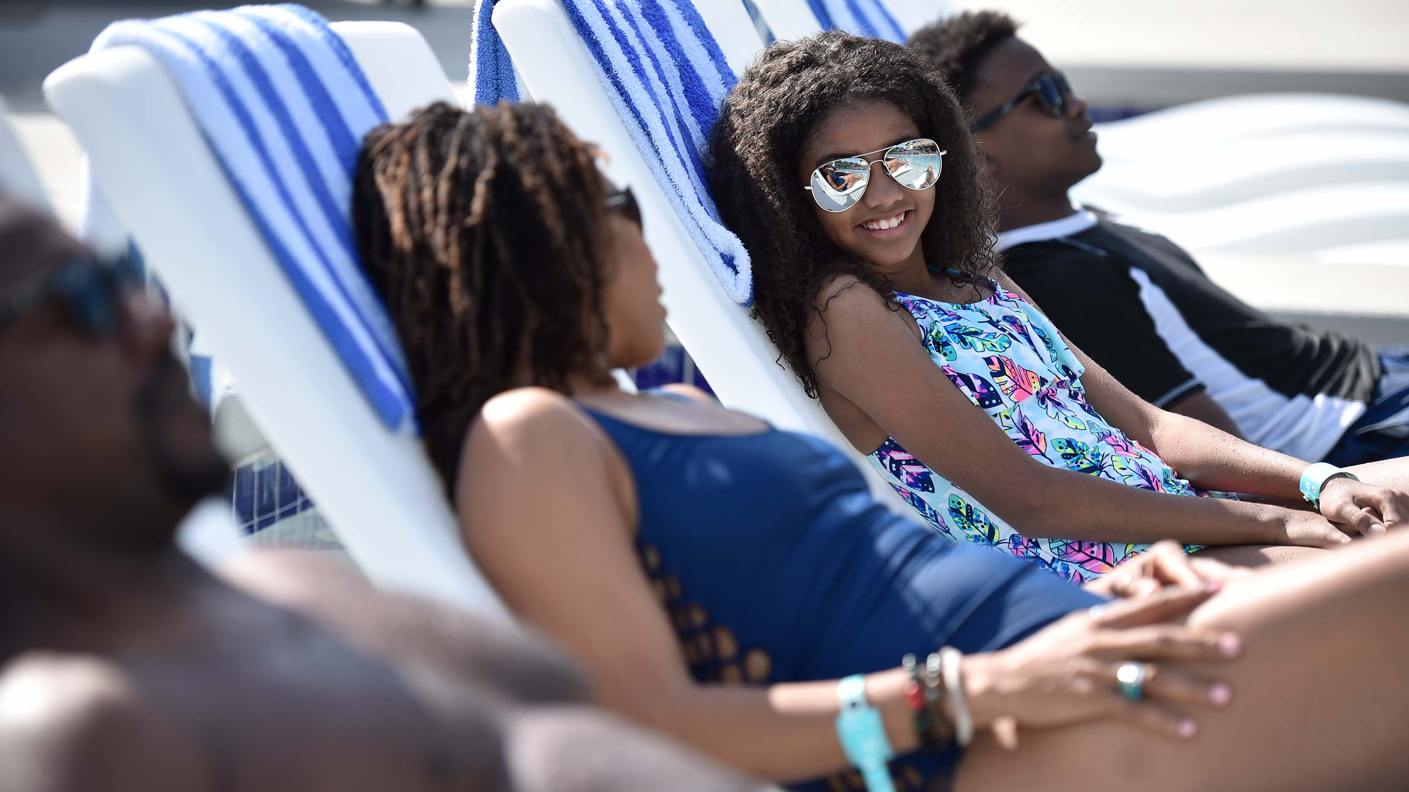 family of four resting on beach chairs