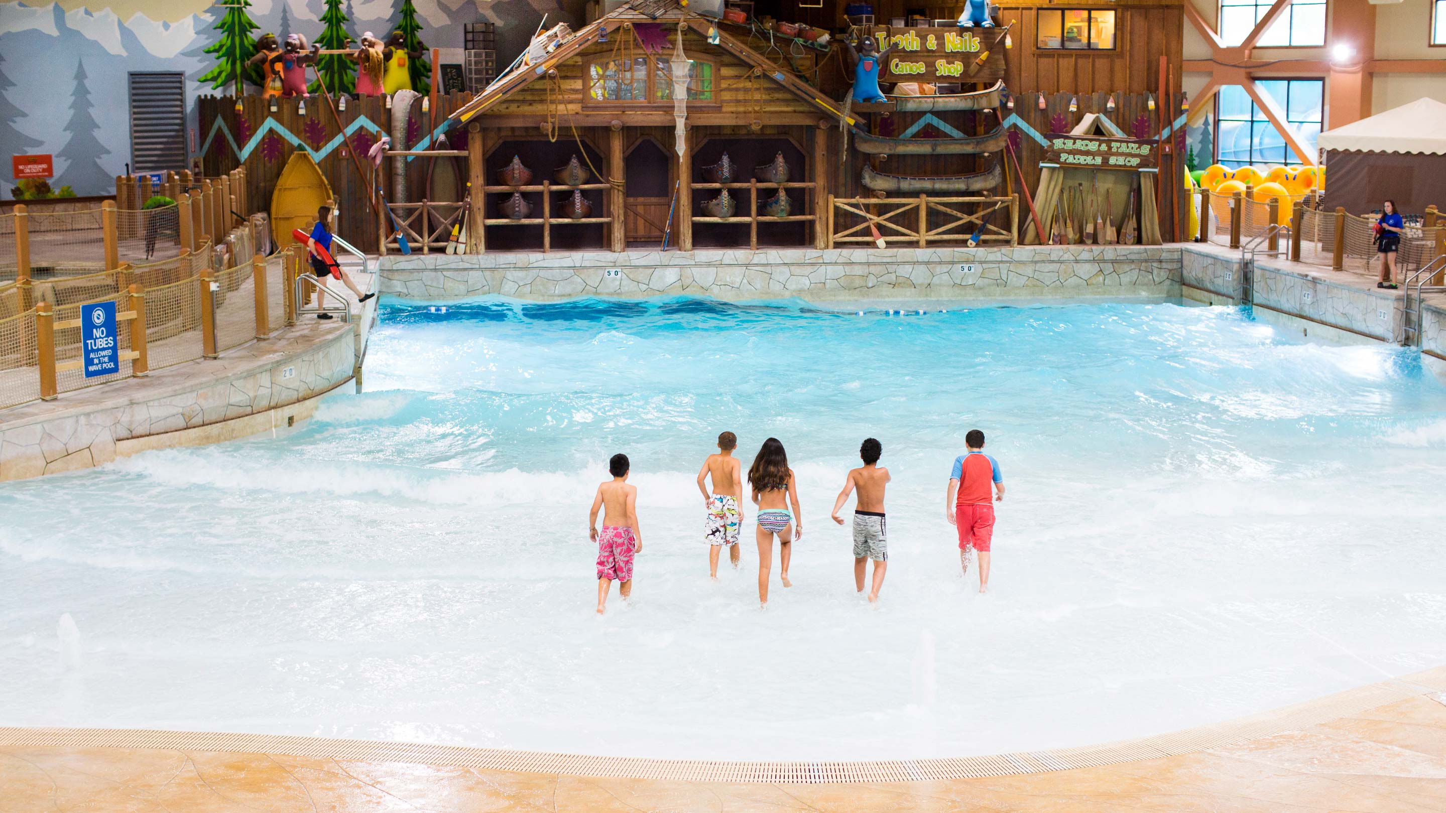 Five children walking into the Rainbow Lake wave pool