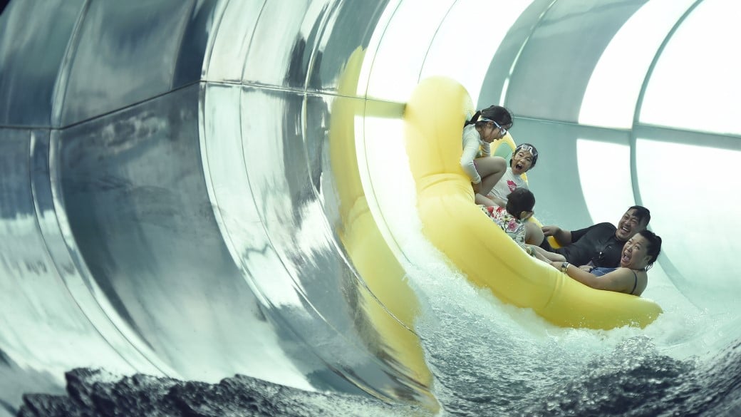 mother father and kids enjoying a water ride