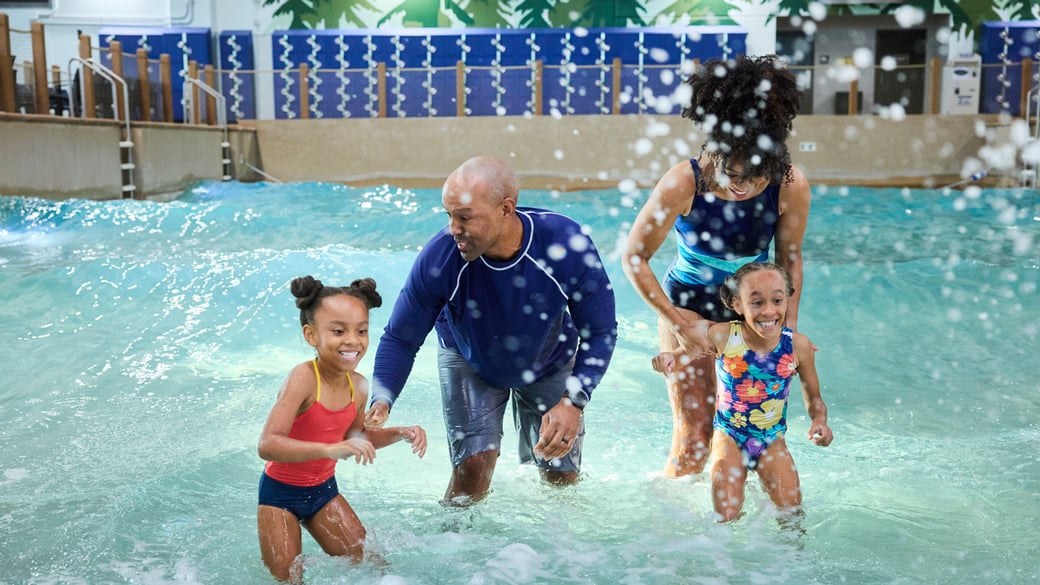 A family playing in water at Rainbow Lake