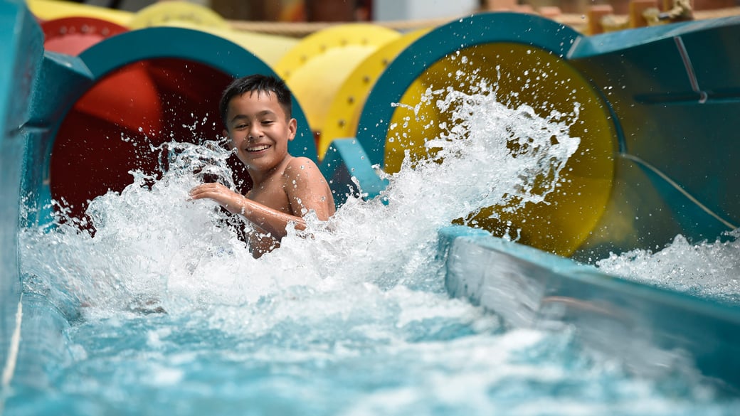 Boy coming out a water slide