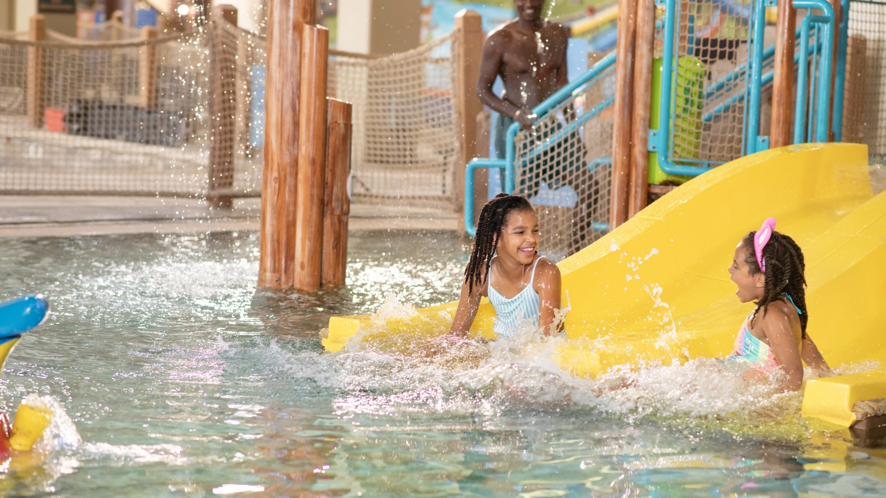 Sisters enjoying water splashing on them